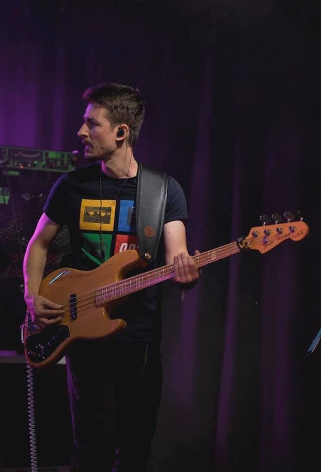 Igor Odaryuk playing a natural finish jazz bass on stage